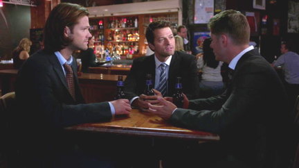 Sam, Dean, and Cas share a beer. Sam, Dean, and Cas share a beer.